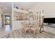 Dining area featuring a glass-top table, stylish chairs, and a chandelier, with access to the kitchen at 4260 Placida Rd # 13B, Englewood, FL 34224