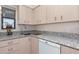 Kitchen area showcasing stylish cabinets, granite countertops, stainless steel sink, and a dishwasher at 4260 Placida Rd # 13B, Englewood, FL 34224
