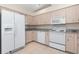 Bright kitchen featuring white appliances, plenty of cabinet storage, and granite countertops at 4260 Placida Rd # 13B, Englewood, FL 34224