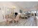 Comfortable living and dining area filled with natural light, stylish furnishings, and wood-style floors at 4260 Placida Rd # 13B, Englewood, FL 34224