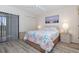Relaxing primary bedroom with wood-look floors, a large window, and ample closet space at 4260 Placida Rd # 13B, Englewood, FL 34224