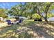 Expansive backyard features a fire pit, seating area, and mature shade trees at 4359 Pocatella Ave, North Port, FL 34287