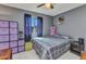Cozy bedroom featuring gray walls, tiled floor, and a window with bright natural light at 4359 Pocatella Ave, North Port, FL 34287