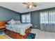 Comfortable bedroom with ample natural light, ceiling fan, and neutral tones, providing a relaxing atmosphere at 4359 Pocatella Ave, North Port, FL 34287