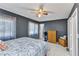 A well-lit bedroom with neutral walls, tiled floors, a fan, and a view to the outside at 4359 Pocatella Ave, North Port, FL 34287