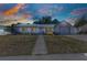 Charming single-story home with a concrete walkway leading to the front door, complemented by a two-car garage and cozy landscaping at 4359 Pocatella Ave, North Port, FL 34287