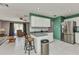 Spacious kitchen with stainless steel appliances and bar stool seating overlooking living area at 4359 Pocatella Ave, North Port, FL 34287