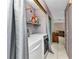Functional laundry area featuring a washer, dryer, and storage shelves, optimizing convenience and organization at 4359 Pocatella Ave, North Port, FL 34287