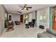 Bright living room featuring tiled floors, a ceiling fan, and large window that brings in natural light at 4359 Pocatella Ave, North Port, FL 34287