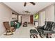 Cozy living room offers tiled flooring, a ceiling fan, comfortable seating, and a mounted TV at 4359 Pocatella Ave, North Port, FL 34287