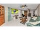 Inviting living room with a large TV, comfortable seating, and dual ceiling fans at 4359 Pocatella Ave, North Port, FL 34287