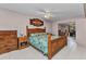 Spacious main bedroom featuring wood furniture and a ceiling fan, offering comfort and style at 4359 Pocatella Ave, North Port, FL 34287