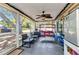 Enjoy outdoor living on this screened patio with comfortable seating and ceiling fan at 4359 Pocatella Ave, North Port, FL 34287