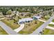 Inviting single-story blue home featuring a metal roof, well-kept yard, and a concrete driveway at 4474 Ozark Ave, North Port, FL 34287