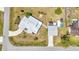 Overhead aerial view of home with a circular driveway, large detached garage, and landscaping at 4474 Ozark Ave, North Port, FL 34287