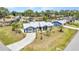 Charming single-story blue home featuring a metal roof and a well-manicured front lawn in a beautiful community at 4474 Ozark Ave, North Port, FL 34287