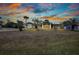 Beautiful home with a lush lawn and a cozy front porch perfect for enjoying evening sunsets at 4474 Ozark Ave, North Port, FL 34287