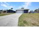 This home features a two-car garage with a long driveway at 4474 Ozark Ave, North Port, FL 34287