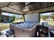 Hot tub with open lid inside of backyard gazebo with roof at 4474 Ozark Ave, North Port, FL 34287