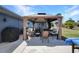 Covered backyard hot tub area with lounge seating at 4474 Ozark Ave, North Port, FL 34287