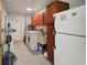 Functional laundry room with washer, dryer, cabinets, sink, and ample space at 4474 Ozark Ave, North Port, FL 34287