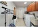 Functional laundry room with washer, dryer, cabinets, sink, and ample space at 4474 Ozark Ave, North Port, FL 34287