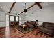 Inviting living room featuring hardwood floors, ceiling beams, and a cozy seating area at 4474 Ozark Ave, North Port, FL 34287