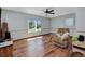 Comfortable living room featuring wood flooring, ceiling fan and a cozy chair at 4474 Ozark Ave, North Port, FL 34287