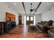 Bright living room with wood floors, beamed ceilings, and comfortable furnishings at 4474 Ozark Ave, North Port, FL 34287