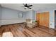 Comfortable living room featuring wood flooring, ceiling fan and a closet at 4474 Ozark Ave, North Port, FL 34287