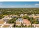 A home viewed from above shows its location within a residential community with scenic views and nearby natural landscape at 4569 Kenvil Dr, North Port, FL 34288