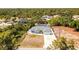 An aerial shot showing the home, driveway, and landscaping, located in a treed neighborhood at 4569 Kenvil Dr, North Port, FL 34288
