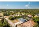 Aerial view of a property surrounded by lush greenery, highlighting its spacious lot and peaceful neighborhood setting at 4569 Kenvil Dr, North Port, FL 34288