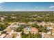This aerial view shows the property's location within a community of homes surrounded by a dense tree line at 4569 Kenvil Dr, North Port, FL 34288