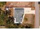 An aerial view of the property featuring a paved driveway and gravel areas surrounding the home at 4569 Kenvil Dr, North Port, FL 34288