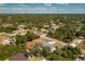 An aerial view showcases the location of the home and its surrounding community near a wooded area at 4569 Kenvil Dr, North Port, FL 34288