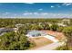 Sweeping aerial view of the property showcasing its prime location and expansive lot with mature trees at 4569 Kenvil Dr, North Port, FL 34288