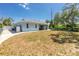 Spacious backyard featuring a well-maintained lawn, screened patio, and privacy fencing for outdoor living at 4569 Kenvil Dr, North Port, FL 34288