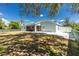 Expansive backyard with lush green grass and a screened patio, perfect for outdoor enjoyment at 4569 Kenvil Dr, North Port, FL 34288