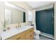 Chic bathroom with a modern vanity, a frameless mirror, and an enclosed shower with a rainfall showerhead at 4569 Kenvil Dr, North Port, FL 34288