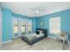 Inviting bedroom with a comfy bed, bright windows, and playful accents, great for relaxation and rest at 4569 Kenvil Dr, North Port, FL 34288