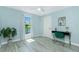 Stylized light blue bedroom featuring desk, wood-look floors and modern ceiling fan at 4569 Kenvil Dr, North Port, FL 34288