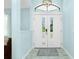 Bright entryway features double doors, modern light fixture, and light wood-look flooring at 4569 Kenvil Dr, North Port, FL 34288