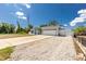 Inviting home with a large driveway, two-car garage, white fence, and well-maintained landscaping at 4569 Kenvil Dr, North Port, FL 34288