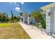 Beautifully landscaped front yard with a well-maintained lawn and a charming walkway leading to the inviting entrance at 4569 Kenvil Dr, North Port, FL 34288