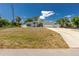 Attractive home with a large front yard, long driveway, and white picket fence, offering great curb appeal at 4569 Kenvil Dr, North Port, FL 34288