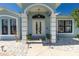 Charming front entrance with double doors, elegant columns, and meticulous landscaping for a welcoming curb appeal at 4569 Kenvil Dr, North Port, FL 34288