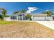 Charming one-story home with a two-car garage, light blue exterior paint, and well-manicured landscaping at 4569 Kenvil Dr, North Port, FL 34288