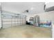 Spacious garage with ample storage, including shelves and a refrigerator, offering versatile space at 4569 Kenvil Dr, North Port, FL 34288