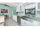 Bright kitchen features a farmhouse sink, white cabinetry, stainless appliances and modern countertops at 4569 Kenvil Dr, North Port, FL 34288